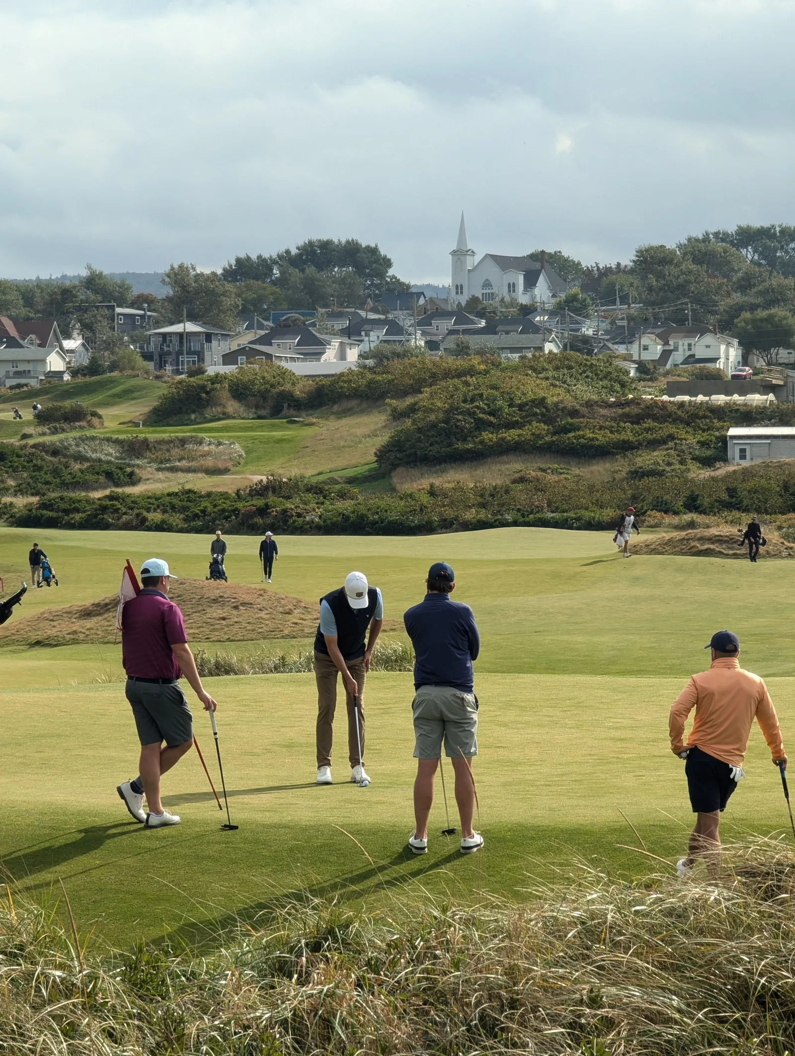 Amateur golfers playing a round on a scenic autumn course