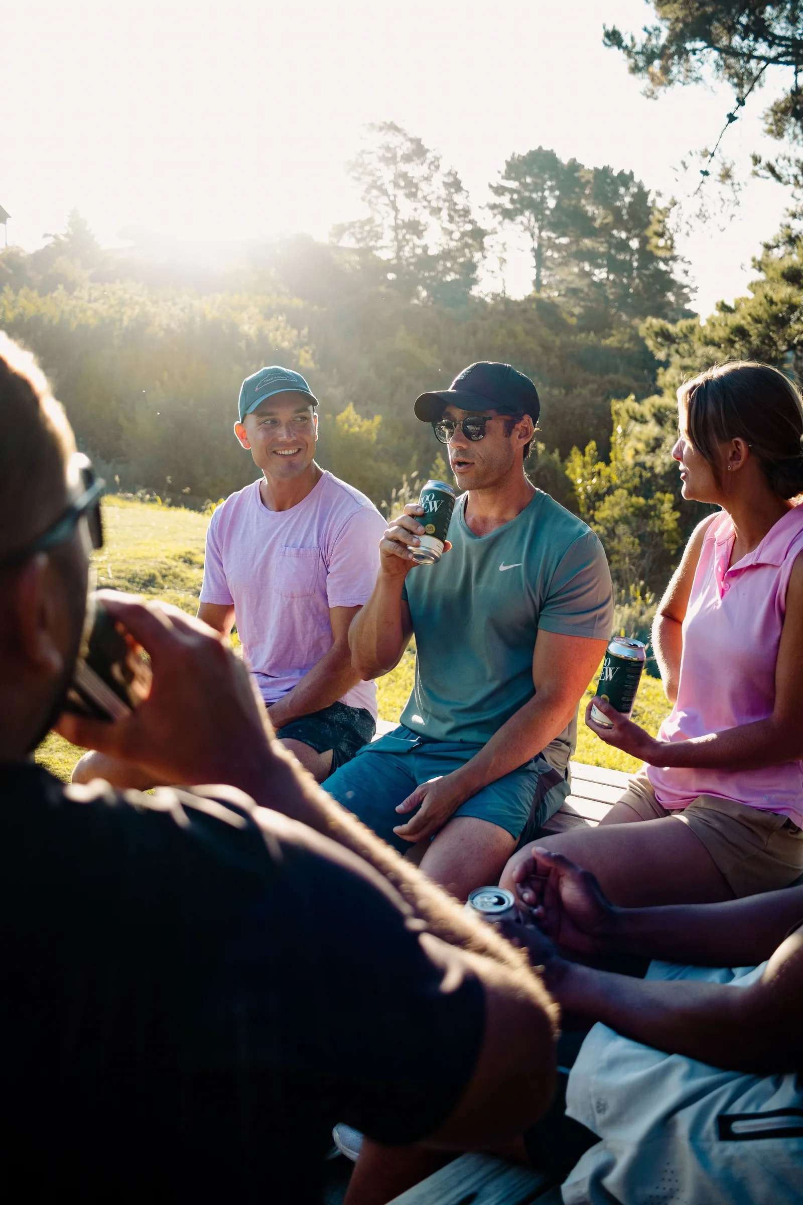 A group of friends enjoying drinks together on a sunny golf course